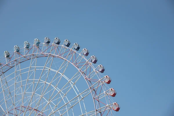 Ferris wheel in a nice clear blue sky with space for text