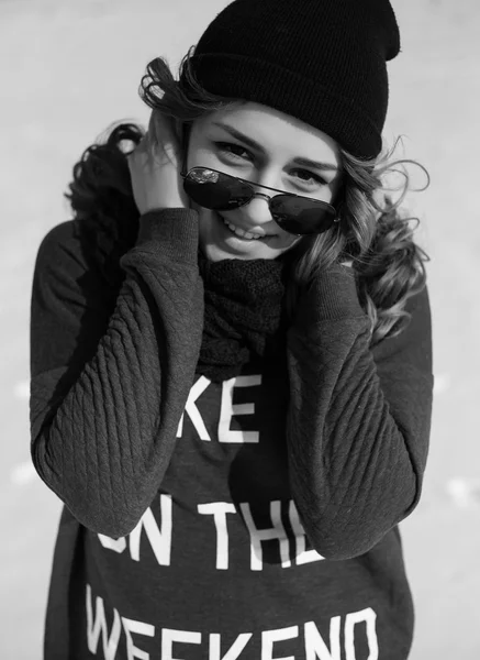 High fashion girl in the sweater and sunglasses outdoor in the winter black and white shot