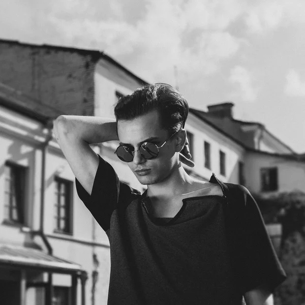 Stylish man in the sunglasses outdoor black and white portrait
