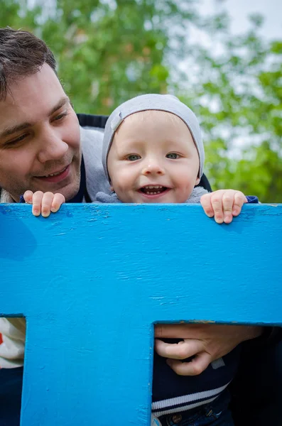 Father and son having fun in playground