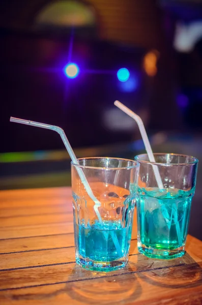 Blue cocktail on bar background