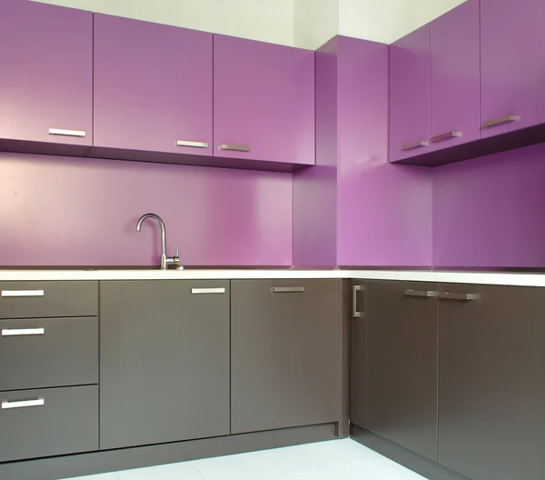 Newly fitted modern kitchen in purple and brown