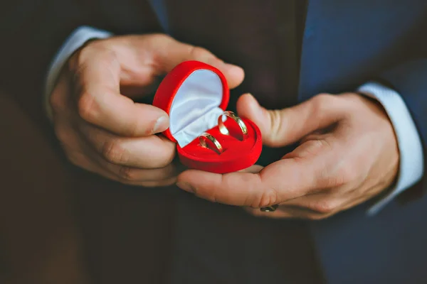 Picture of man with gift box and wedding ring