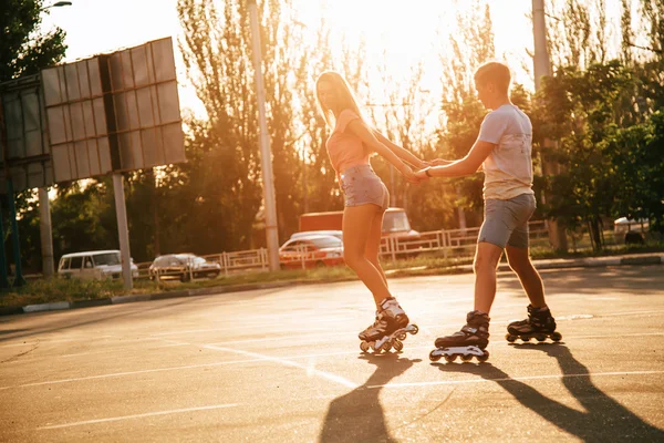 A couple roller-skating at sunset