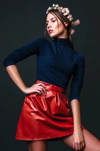 Young sexy girl. Fashion portrait of young beautiful woman in skirt and shirt. Black background