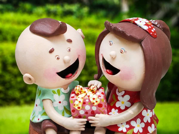 Ceramic doll boy and girl and gift on hands