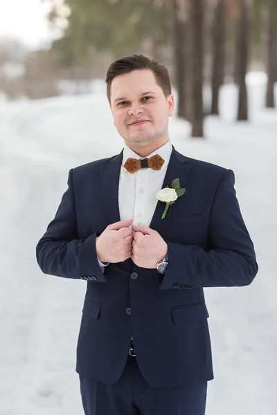 Portrait groom in the winter