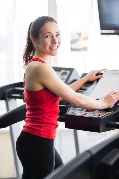 Sports woman is running on the treadmill