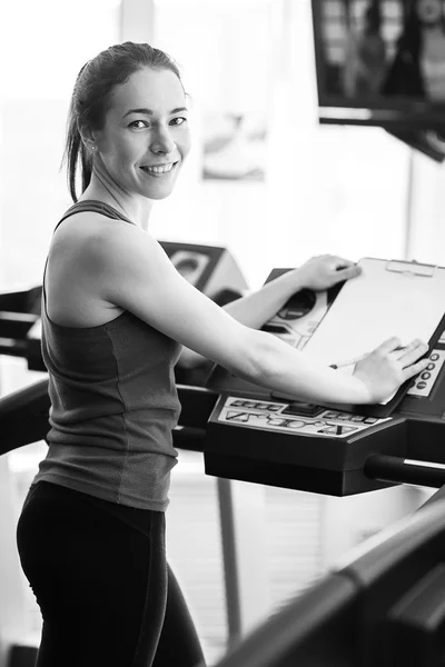 Sports woman is running on the treadmill