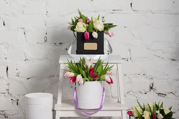 Bouquet of roses and tulips in a gift box