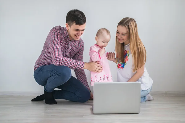 Young happy family running on a laptop