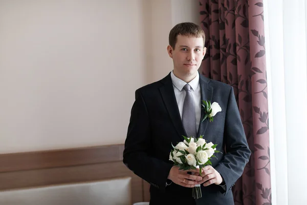 Man holding a bouquet of the bride at a wedding