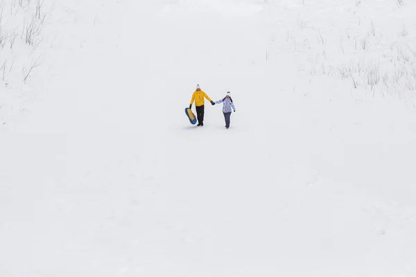 Young happy couple walking in winter park