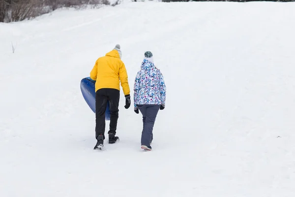 Young happy couple walking in winter park