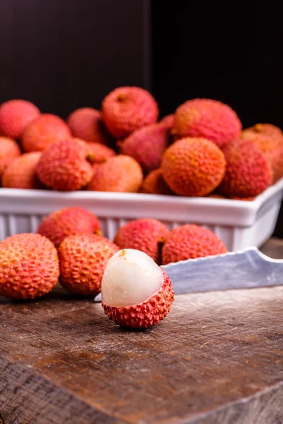 Lychee fruit, which is called Chinese plum, is on the dark Board