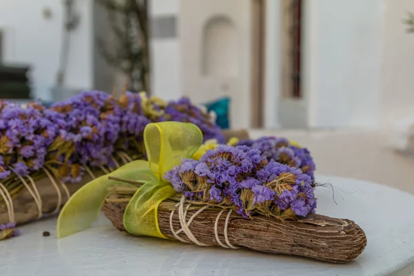 Decorations with violet dried flowers and yellow ribbon with bow