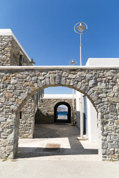 Stone building arches and lanterns with view over the sea