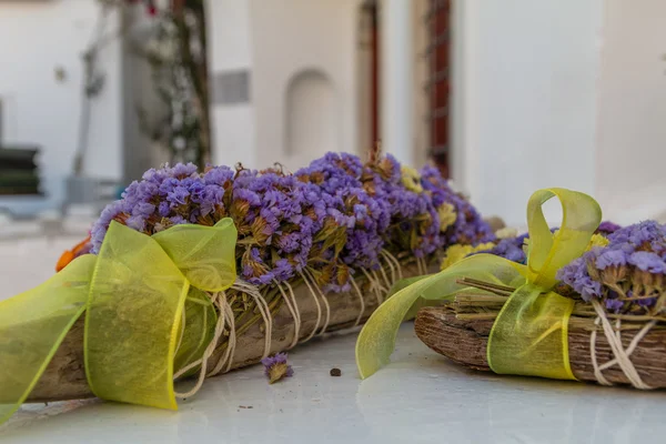 Decorations with violet dried flowers and yellow ribbons with bows