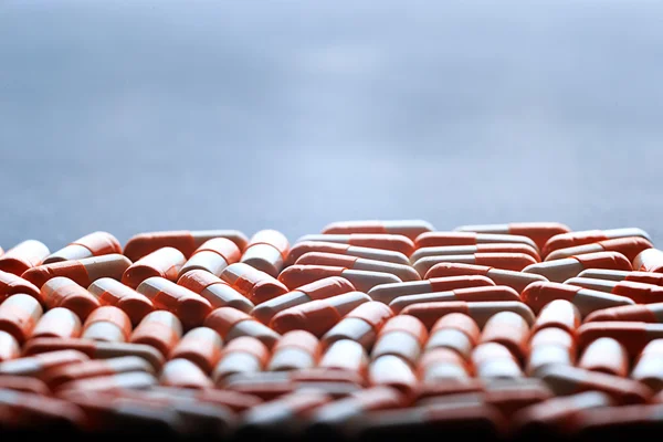 Many medicine orange and white capsules