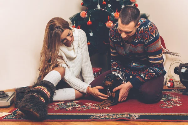 Young couple under christmas tree