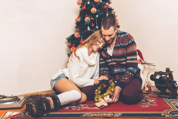 Young couple under christmas tree