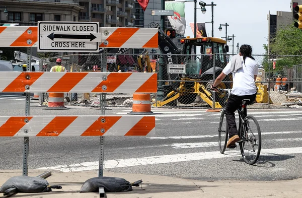 Construction area and sign of sidewalk closed.