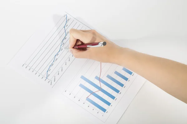 Office worker studying the chart with a pen