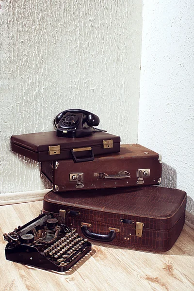Vintage classic brown leather suitcase and retro phone
