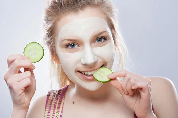 Woman with slice of cucumber