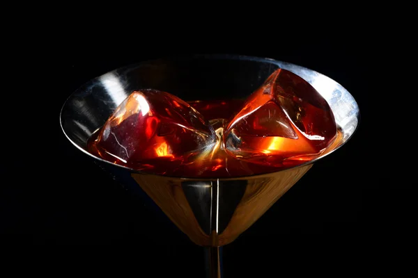Two ice cubes in the steel martini glass