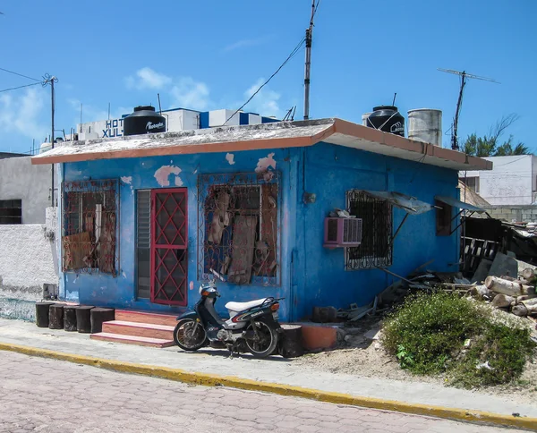 Just a Blue House With a Scooter