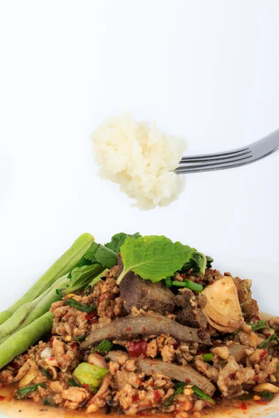 Thai ground pork salad, Spicy minced pork and pork liver salad with sticky rice on fork