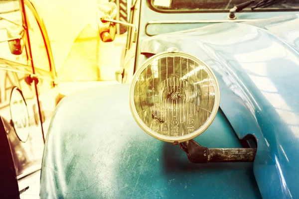 Close Up of Headlight Lamp Blue Vintage Classic Car. (Vintage Effect Style)