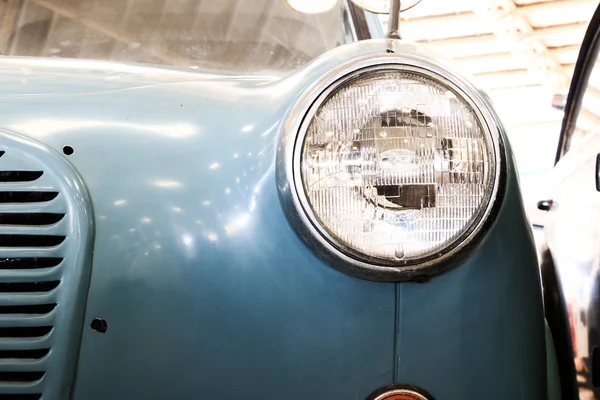 Close Up of Headlight Lamp Blue Vintage Classic Car. (Vintage Effect Style)