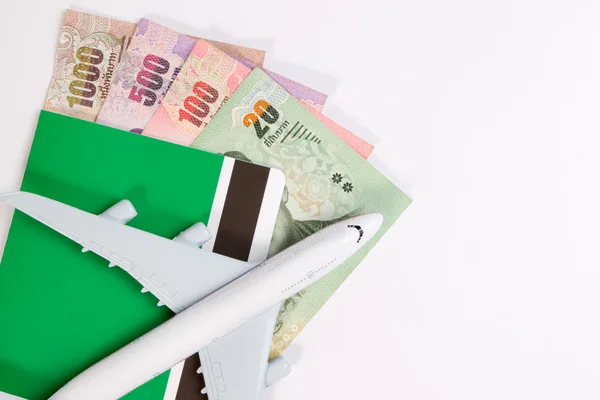 Airplane on Thai money, the rising costs of airline travel. Airline tickets or book bank isolated on white, top view.