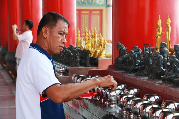 Buddhist is donating money to a Chinese temple by their faith and to maintain the temple.