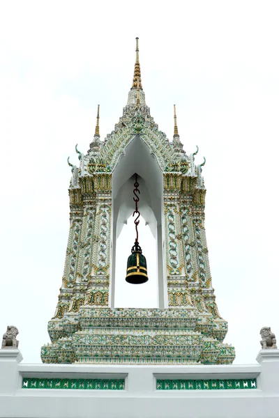 Golden isosceles structure, Delicate painted of Thai Temple Door Entrance and Lion Historic Chinese stone sculpture of a Chinese warrior sculpture in Wat Pho Buddhist Temp