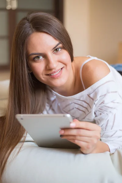 Young smiling woman with tab