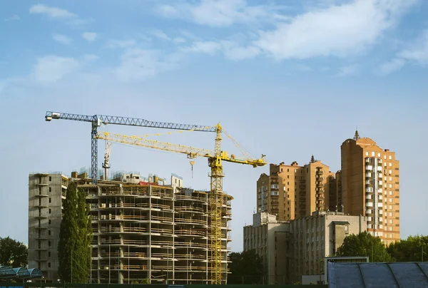 Residential building and construction building with hoisting tower cranes