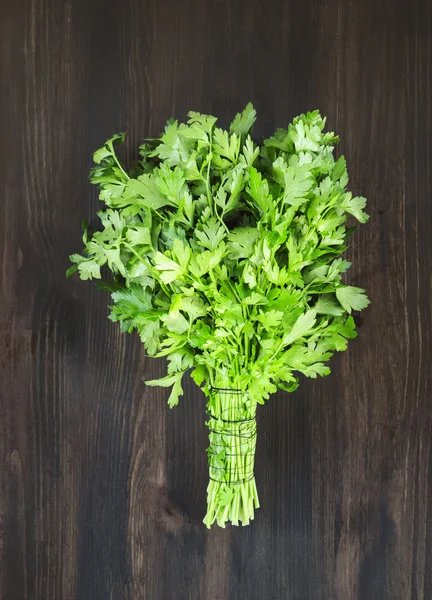 Bunch of parsley on wooden background