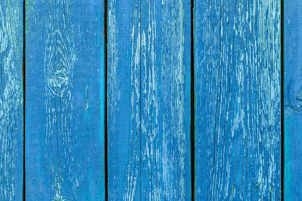 Different shades of blue texture of wood planks as a background nature. Peeling paint on an old green wooden boards. The texture of old wood as background. Country style.