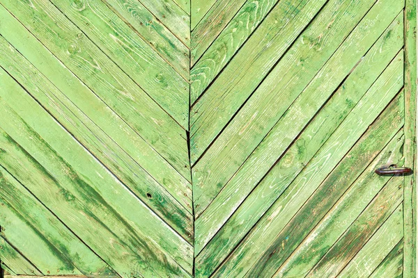 Wooden boards as a background. The texture of the fence. Vintage effect. Wooden boards green diagonally. old peeling paint. Copy space.