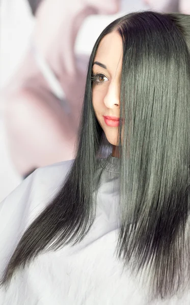 Barber Stylist makes hairstyle on the long hair of the equipment, the beauty industry