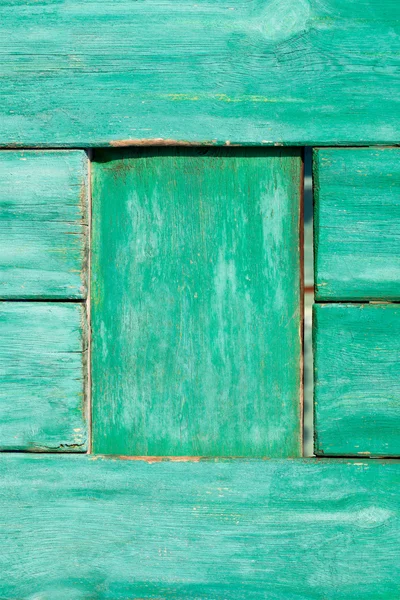 Old painted wooden wall texture or background with copy space. Wooden planks painted old green.