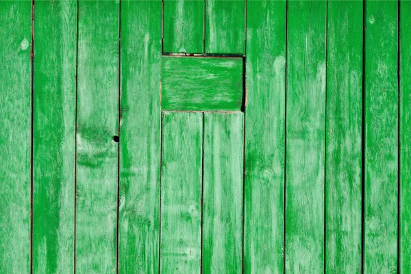 Old painted wooden wall texture or background with copy space. Wooden planks painted old green.