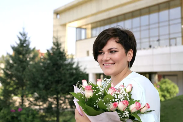Portrait of a smiling woman Caucasian appearance with a bouquet