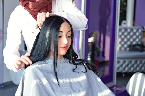 Job hairdresser and stylist. A girl with long black hair