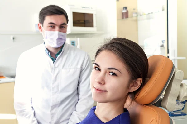 Dentist in a dental clinic. Girl smiling