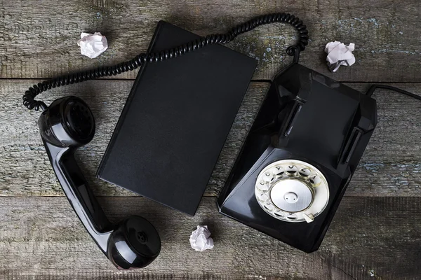 Vintage black phone and notebook