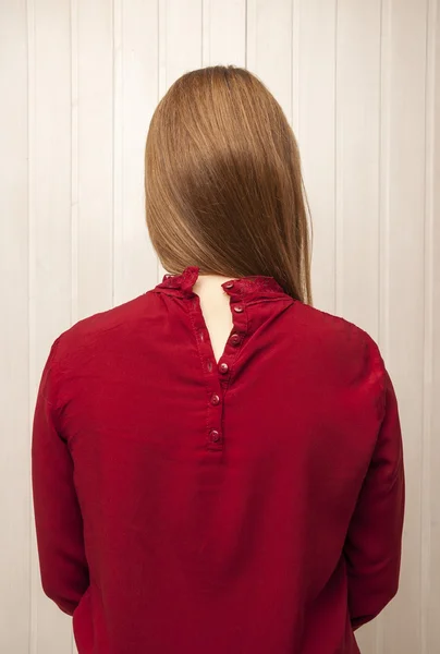 Girl in red buttoned on the back shirt.